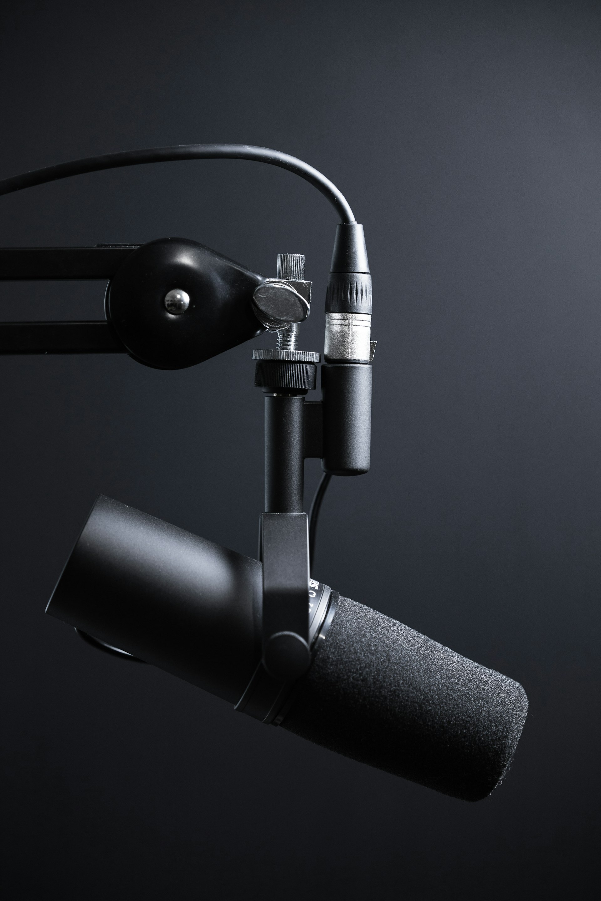 Content creator recording with professional podcast microphone in home studio setup