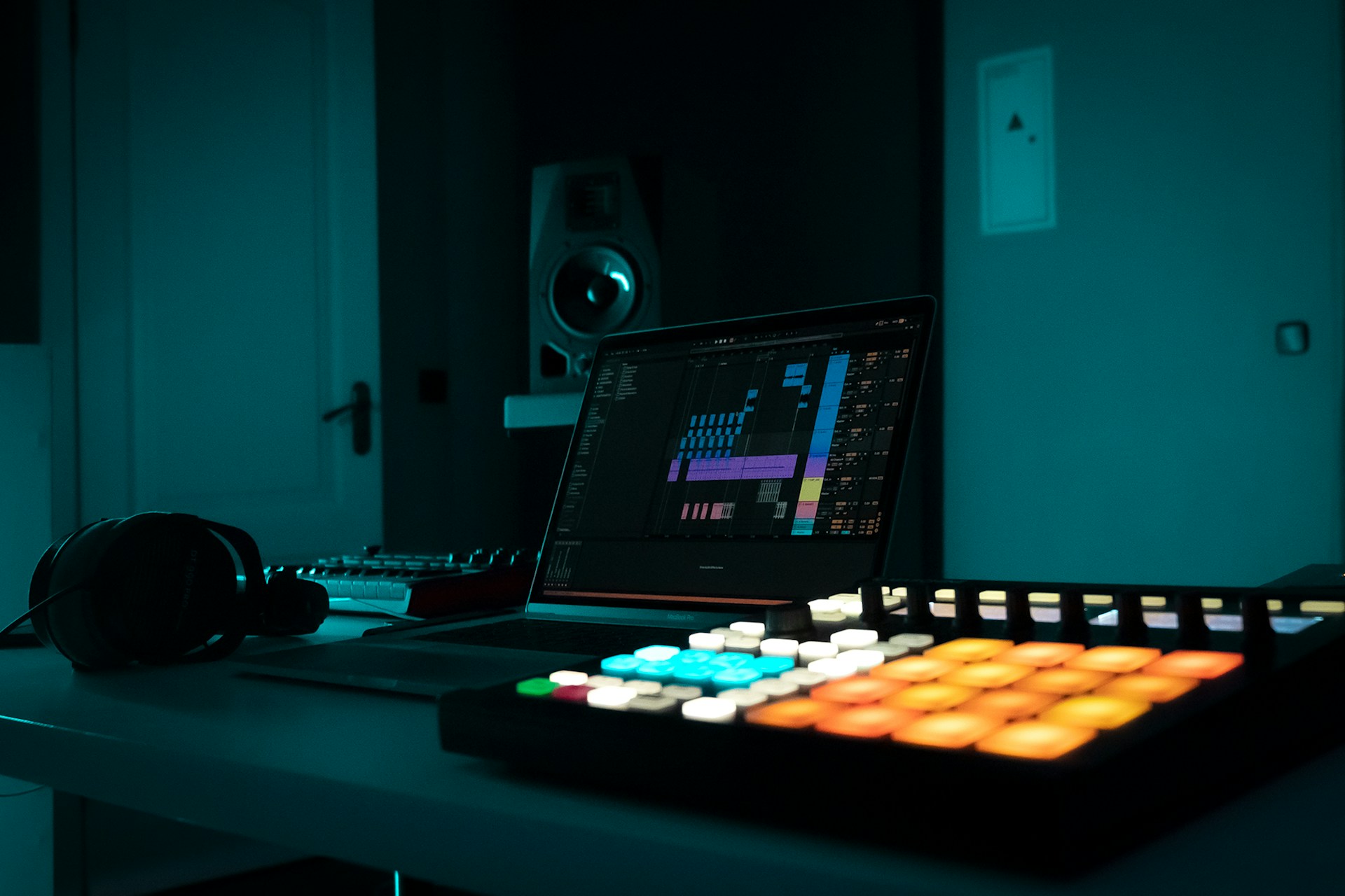 Content creator with laptop and headphones in music production environment