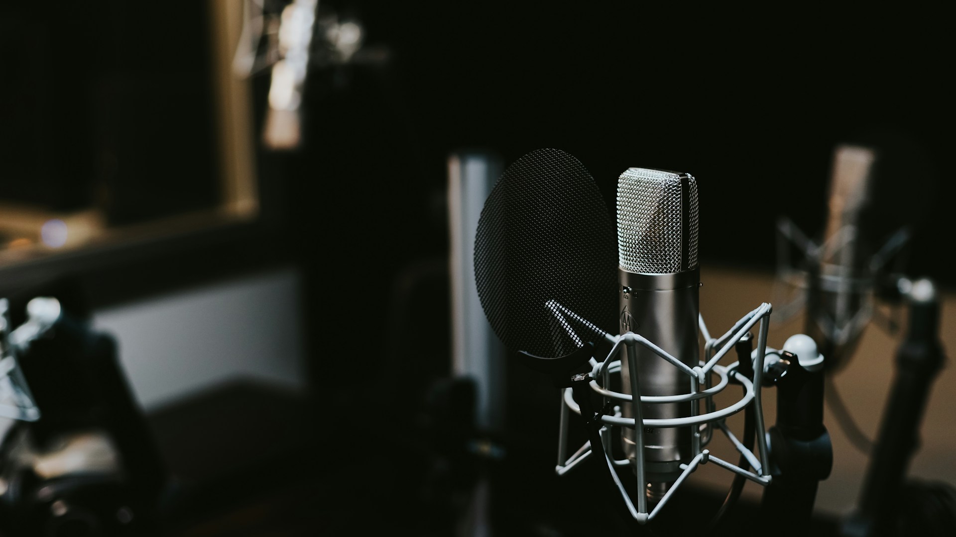 Headphones and microphone on a desk for audio recording