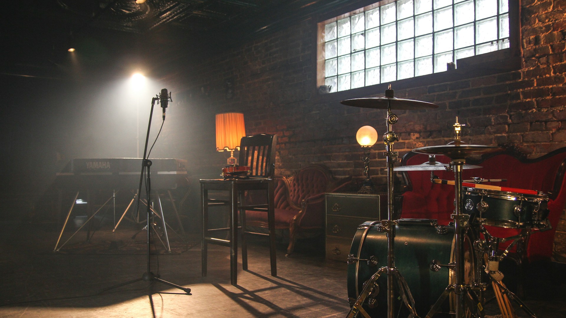 Professional music production setup with mixing board and studio equipment in warm lighting