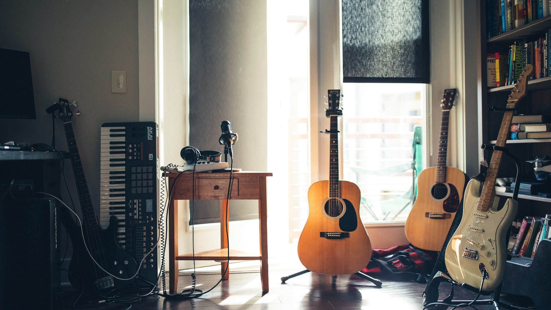 Music producer listening to tracks with headphones in creative studio environment