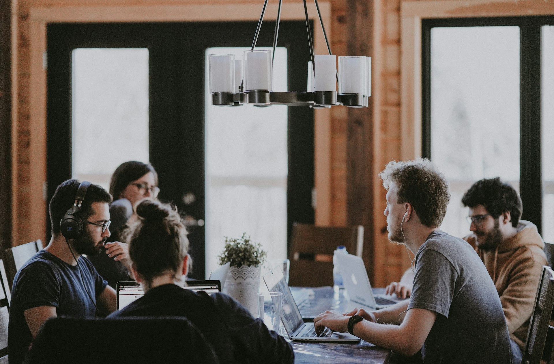 Team members collaborating around a conference table in a bright office